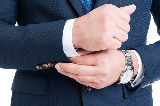 istock Businessman fixing and adjusting white shirt sleeve under blue s 521692244