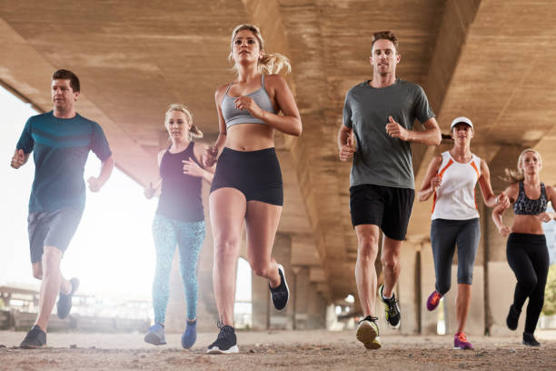 istock Determined group of young people running in city 521693442