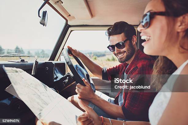 Happy Young Couple With A Map In The Car Stock Photo - Download Image Now - Car, Road Trip, Planning