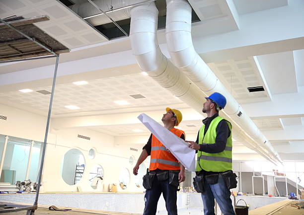 Construction workers reading blueprints stock photo