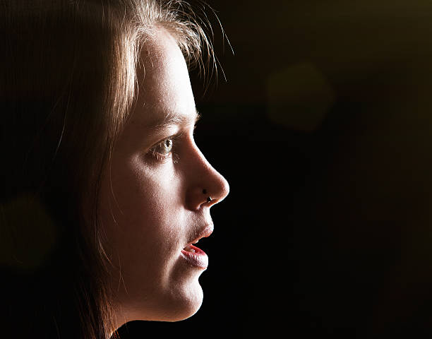 istock Profile of beautiful girl on black with copy space 521697136