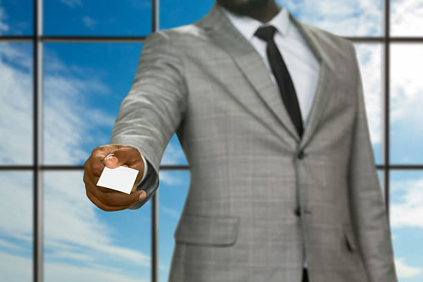 istock Afro businessman giving visit card. 521697228