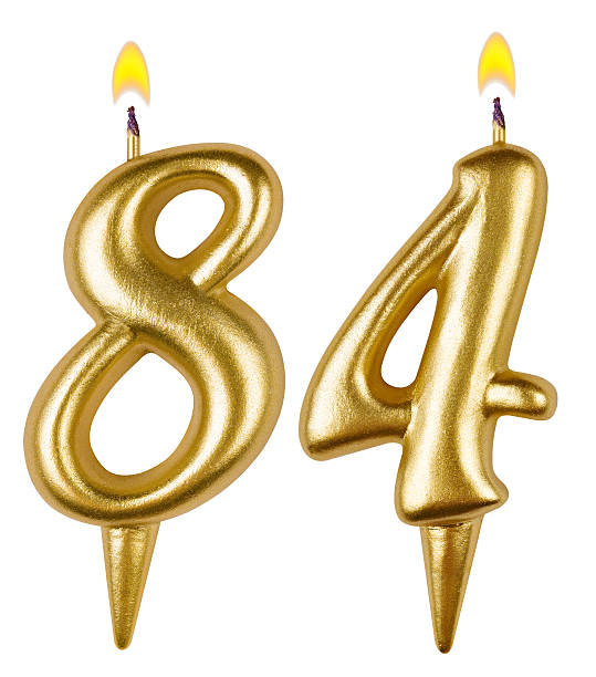istock Birthday candles number eighty four isolated on white background 521697297