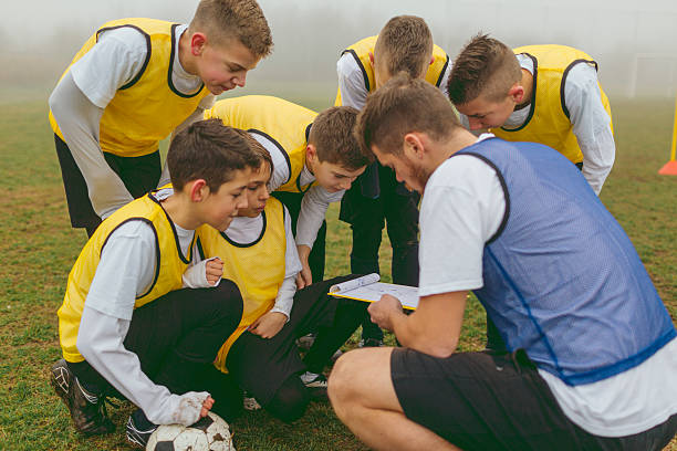 istock Kids Talking With Their Coach About Soccer Strategy 521697718
