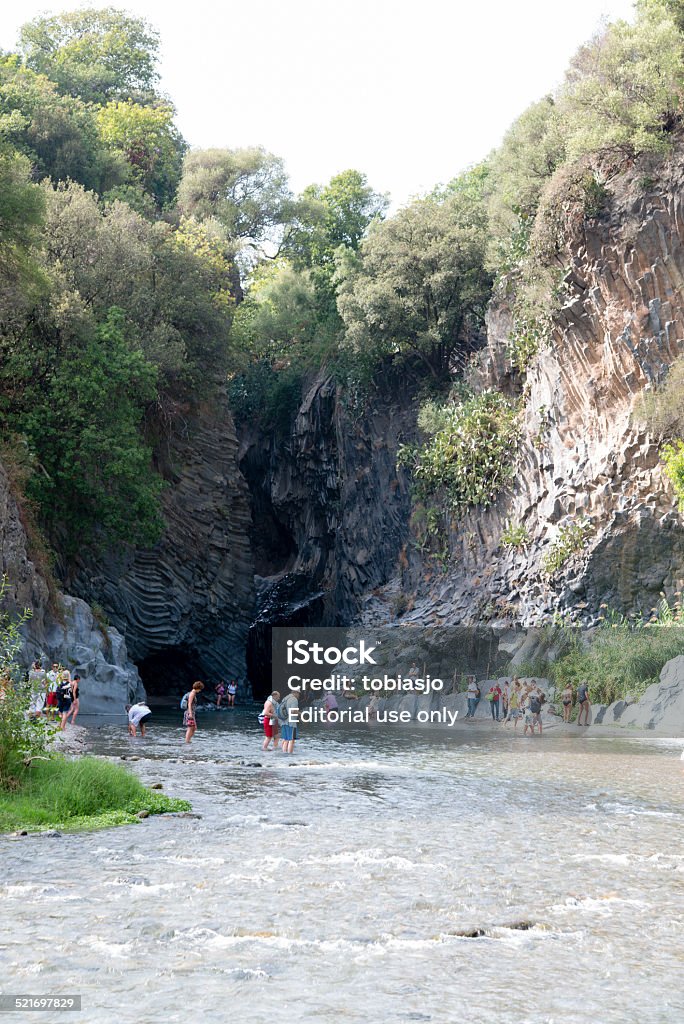 Alcantara River Sicily Francavilla, Italy - September 21, 2014: People walking in the cold river of Alcantara Gorge during a hot summer day, near the volcano of Mt Etna and the city of Taormina, Sicily. Cliff Stock Photo