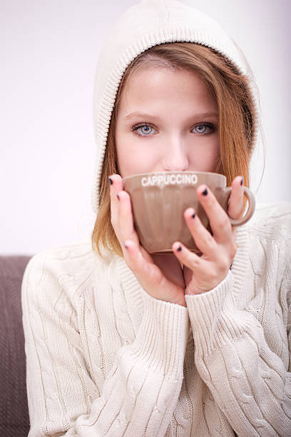 istock young woman drinking cappuccino 521697923