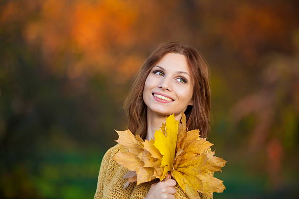 istock woman in beige sweater with leaves 521697969