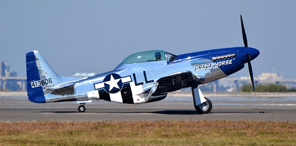 Jacksonville, USA - October 25, 2014: A vintage World War II P-51 Mustang prepares for take-off on the runway of Naval Air Station Jacksonville.