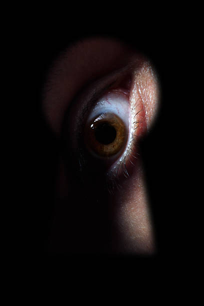 istock Eye spying through the keyhole 521699818