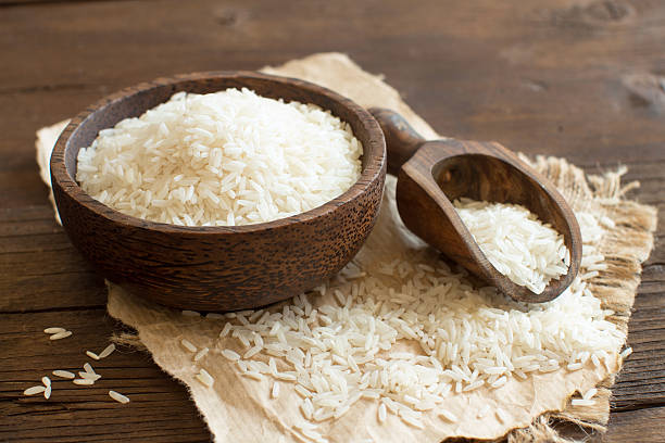 istock Pile of Basmati rice in a bowl with a spoon 521700494
