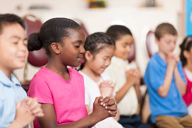 Sunday School Kids reading the bible in Sunday School. bible study group of people small group of people stock pictures, royalty-free photos & images