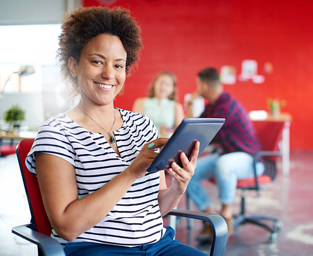 istock Confident female designer working on a digital tablet in red 521701626