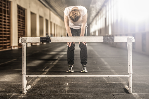 exercise in the gym, the girl has been running through the barrier, the girl standing in front of the barrier