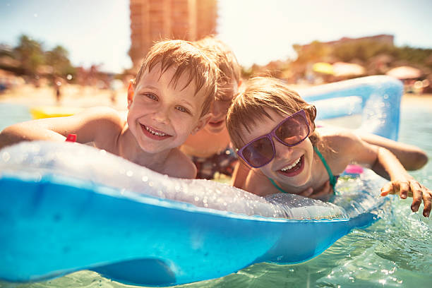 istock Kids having fun in sea on air bed 521702328