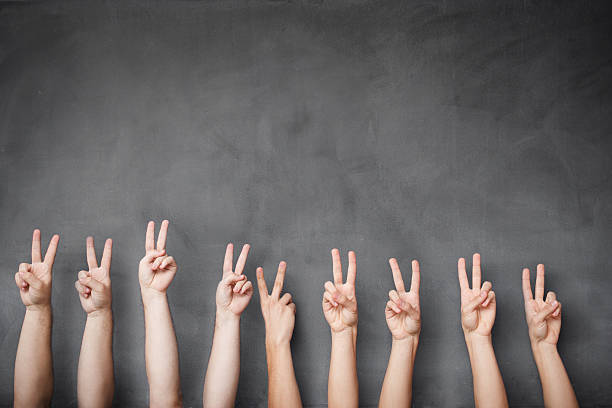 istock Victory sign hands of a group on blackboard 521703125