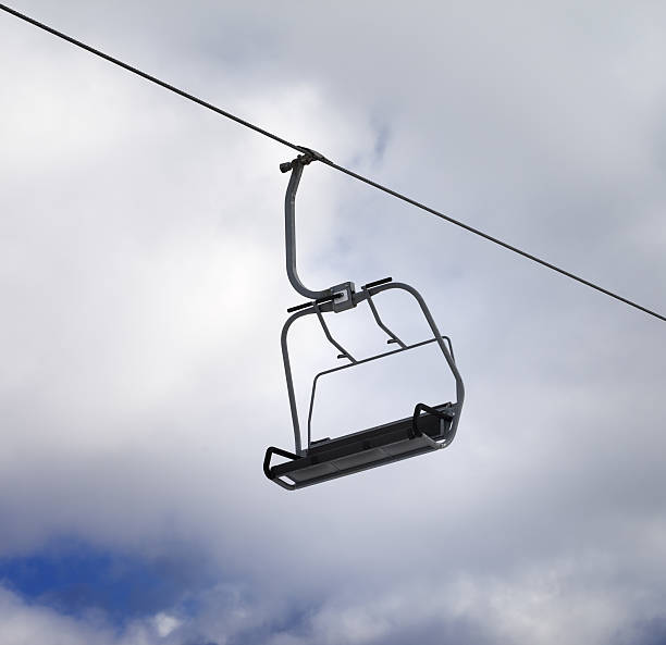 istock Chair-lift and cloudy sky 521703781
