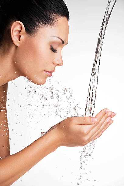istock woman washing her clean face with water 521705070