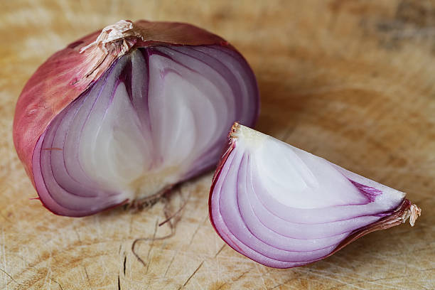 istock Fresh red onions on a wooden background 521705788