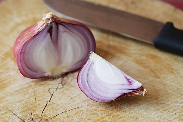 istock Fresh red onions on a wooden background 521706082