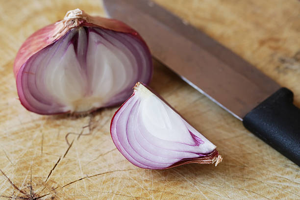 istock Fresh red onions on a wooden background 521706164