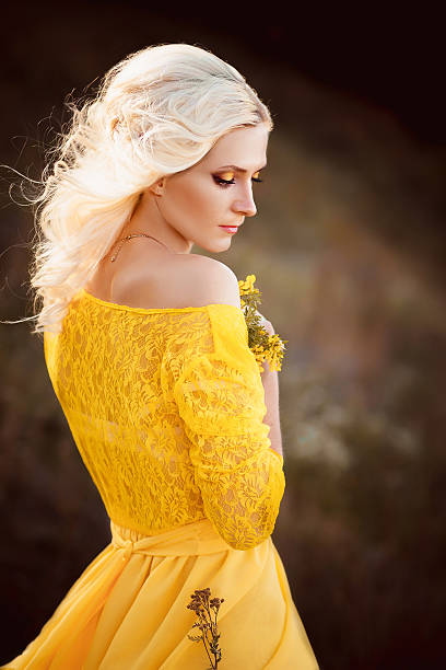 istock beautiful lady in a long yellow dress 521706370