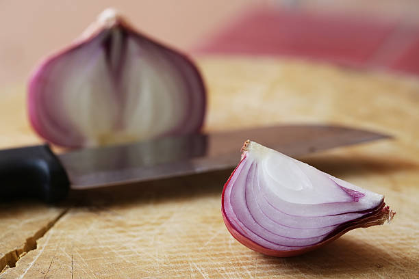 istock Fresh red onions on a wooden background 521706882