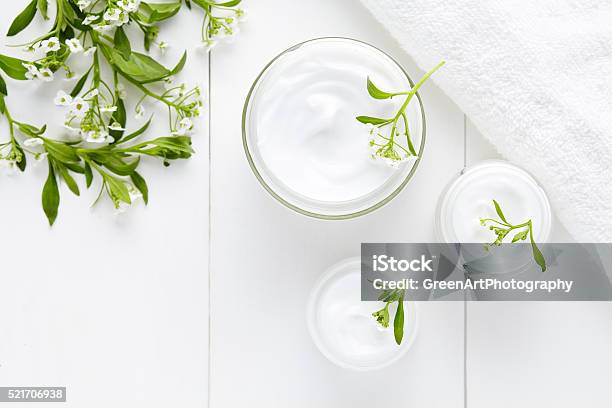 Herbal Bodycare Cosmetic Hygienic Cream With Flowers Stock Photo - Download Image Now