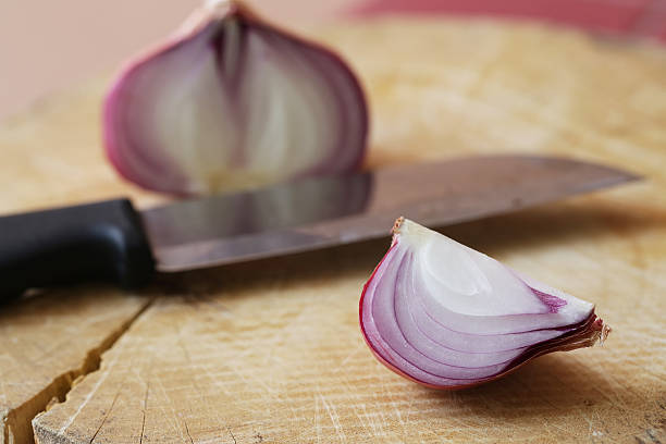 istock Fresh red onions on a wooden background 521707066