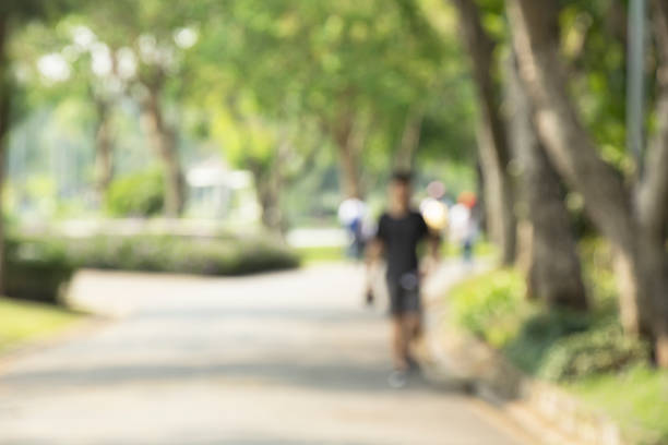 istock Blurred image of people jogging in the park. 521707244