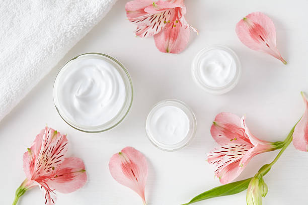 Herbal spa cosmetic cream with pink flowers hygienic skincare lotion stock photo