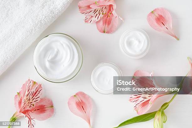 Herbal Spa Cosmetic Cream With Pink Flowers Hygienic Skincare Lotion Stock Photo - Download Image Now