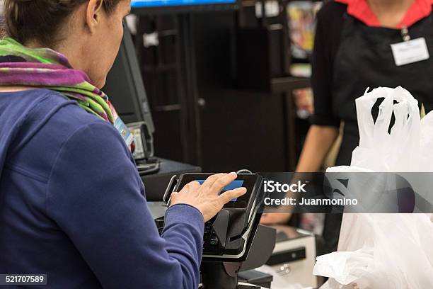 Caucasian Woman Electronic Signing Her Bill Stock Photo - Download Image Now - ATM, Only Women, Women