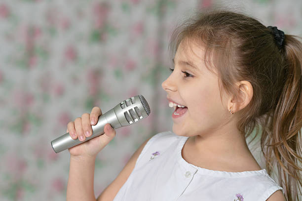 istock Beautiful little girl with microphone 521707664