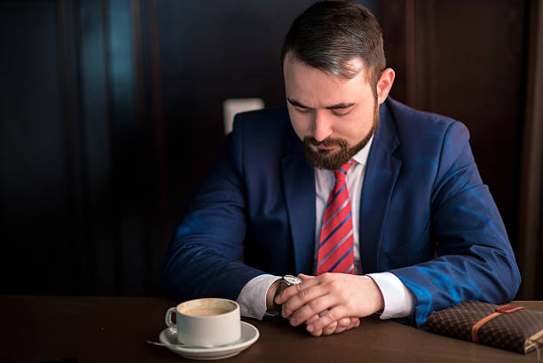 istock businessman looks at the clock 521708016