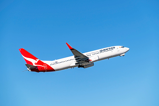 Melbourne, Australia - April 17, 2016: On a clear, sunny autumn day, Qantas Boeing 737-838 VH-VXB aeroplane lifts off the runway and becomes airborne.  The plane named Yananyi” is on flight QF444, a domestic service to Sydney along the world’s third busiest air corridor.