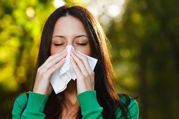 istock Woman blowing nose 521710011