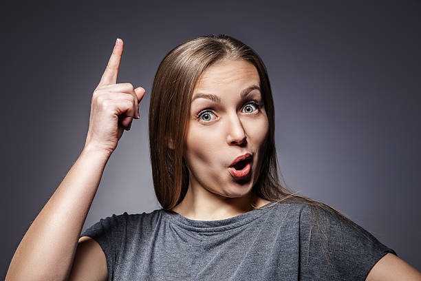 istock Woman having a good idea on dark grey 521711615