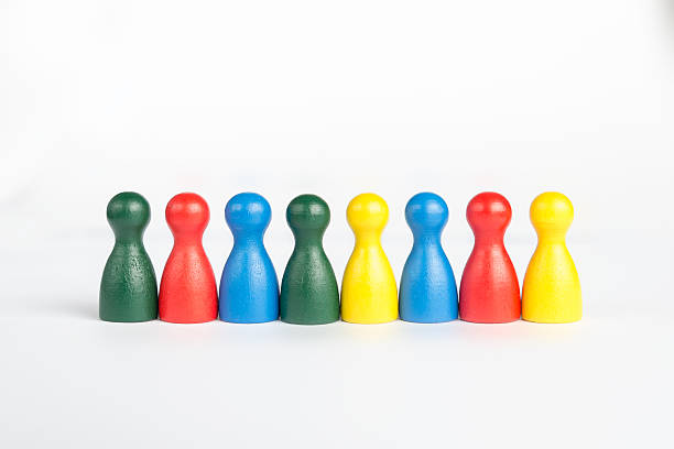istock Different colors of game figurines in a line 521714747