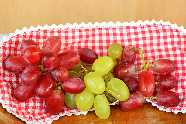 Close-up picture of grape and muscat on a red background.