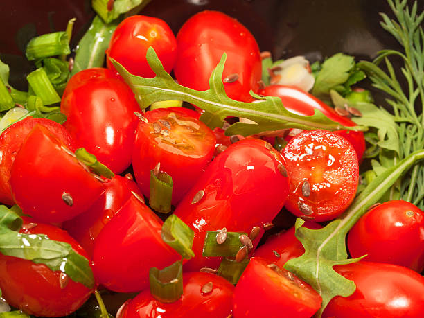 istock cherry tomatoes in the salad with greens. macro 521723317