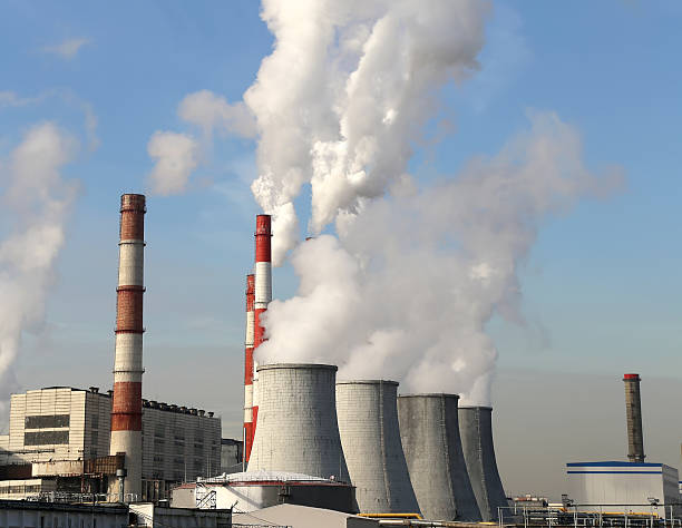 istock Coal burning power plant with smoke stacks 521724477