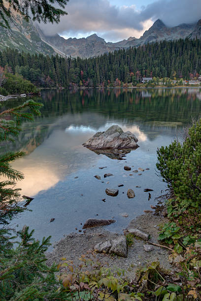 istock Mountains and trees reflected in Lake Europe 521727511