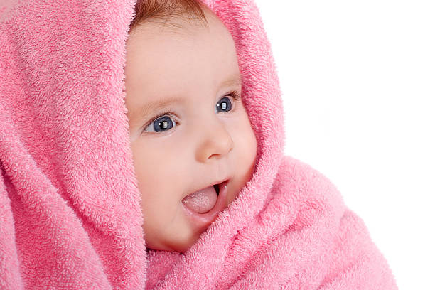 istock smiling baby in pink towel 521728605