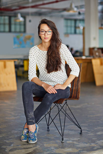 I've my eyes on success Portrait of an attractive young woman sitting in an office legs crossed at ankle stock pictures, royalty-free photos & images