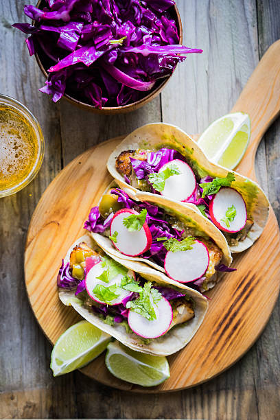 istock Fish tacoes on wooden background 521740513