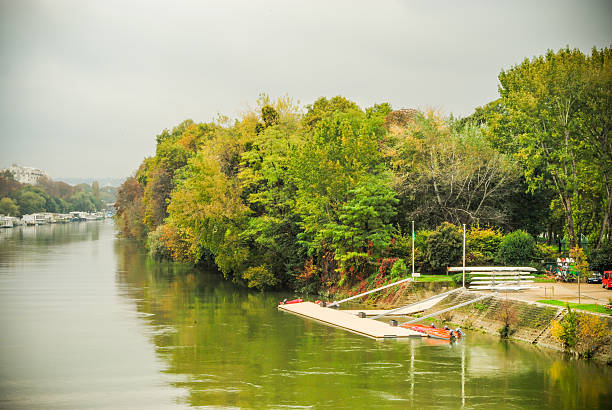 istock Paris river Seine view with trees and boats docking 521743303