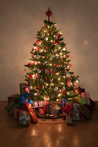 Beautiful christmas tree with lights and presents