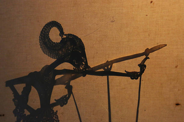 Indonesia: Javanese Shadow Puppet Performance A Javanese wayang kulit (shadow puppet) performance in Yogyakarta. Performances of shadow puppet theatre are accompanied by a gamelan orchestra in Java. It is an ancient tradition throughout Java and all of Indonesia. wayang kulit stock pictures, royalty-free photos & images