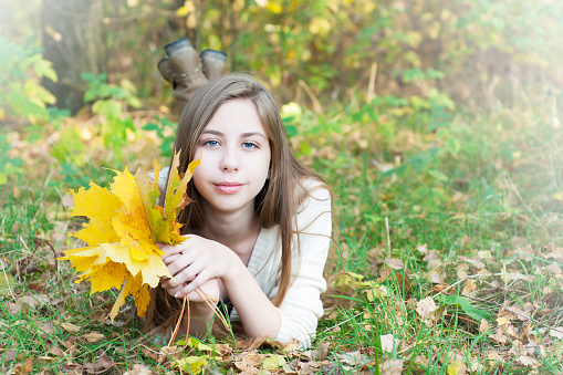 Portrait of very beautiful young girl in autumn park