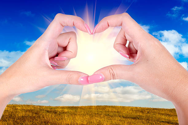 istock hands in the form of  heart over a blue sky 521760087